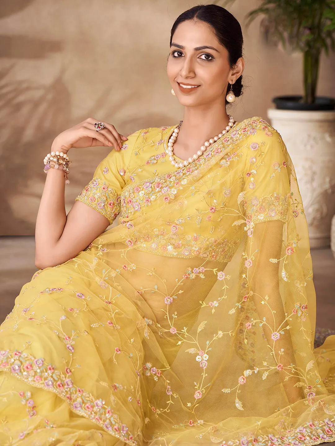 Yellow Net base embroidered and zarkan work saree