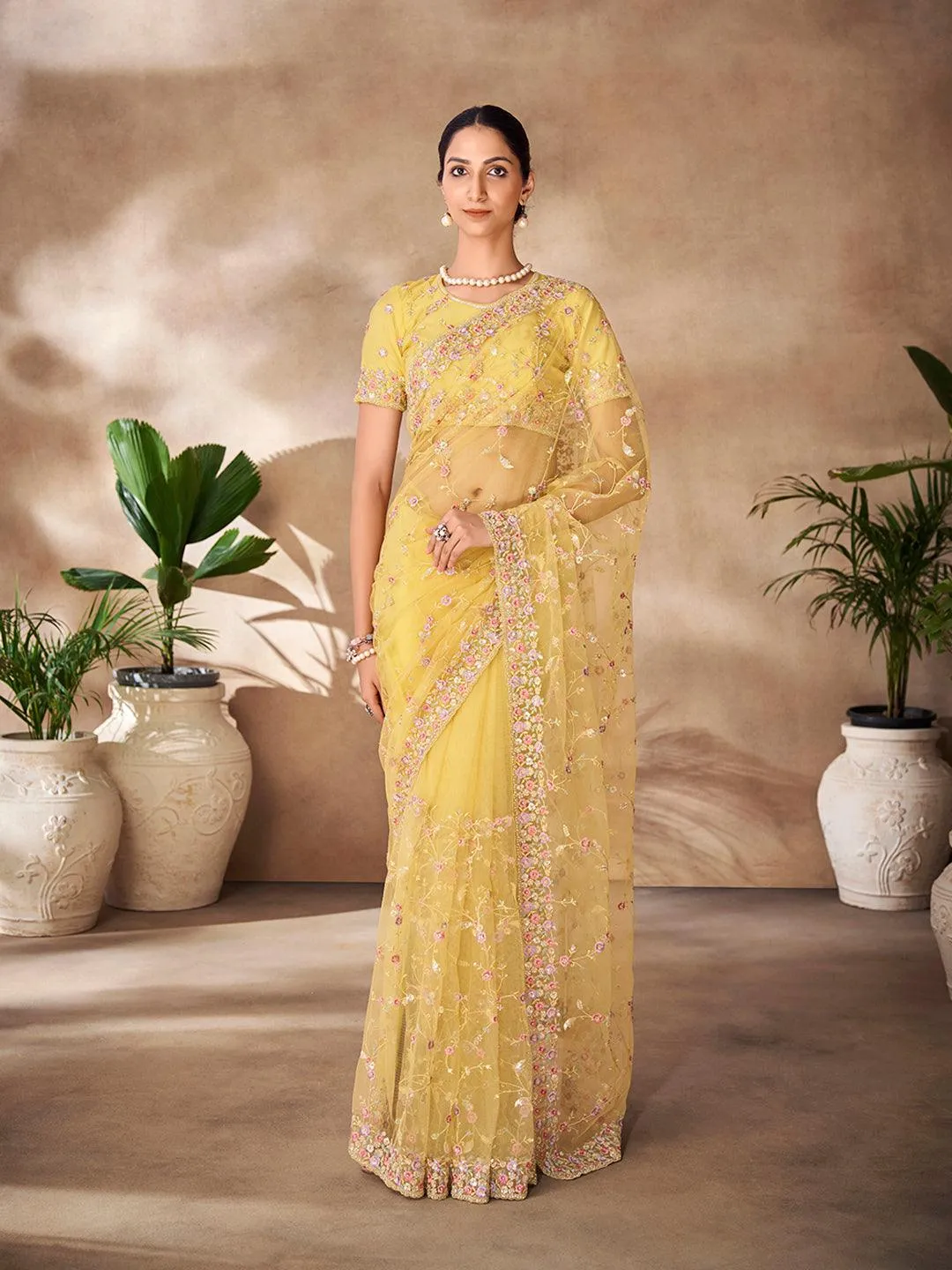 Yellow Net base embroidered and zarkan work saree