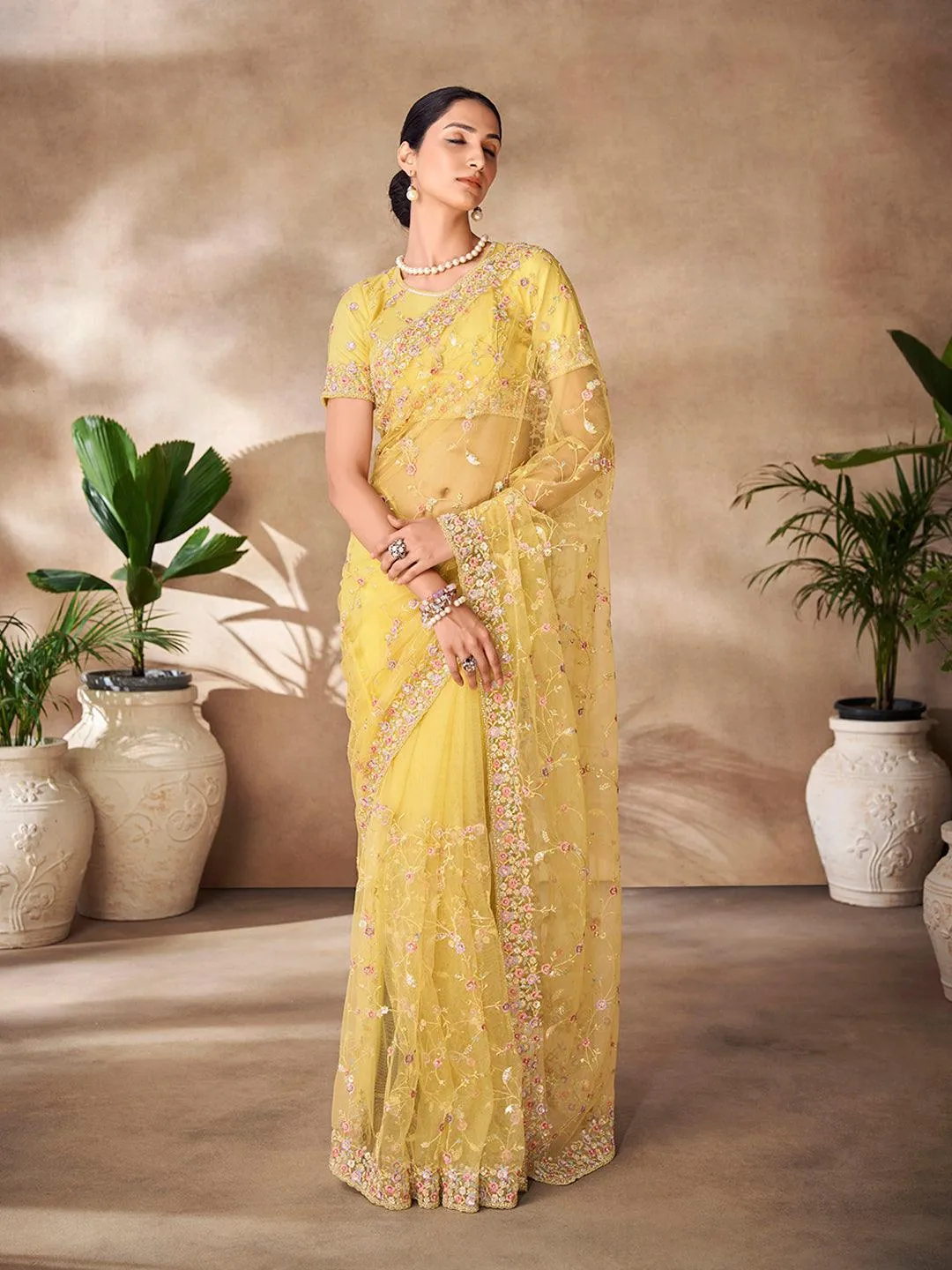 Yellow Net base embroidered and zarkan work saree